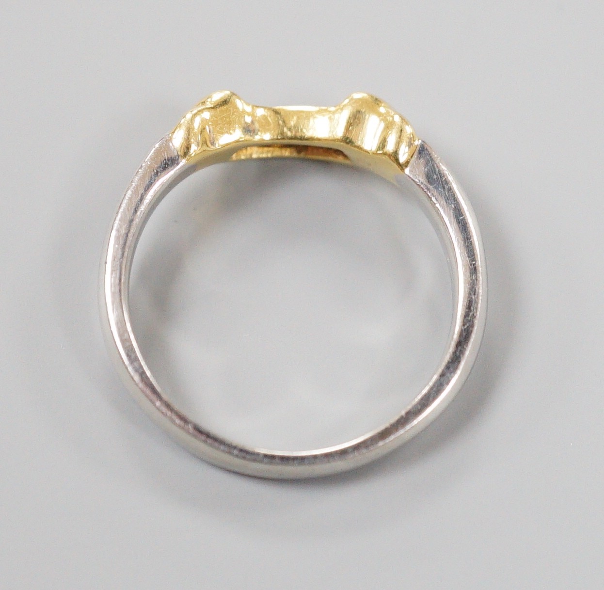 A modern platinum and yellow metal, four stone diamond set demi-lune ring, size N/O, gross weight 5.4 grams (part of a wedding set)